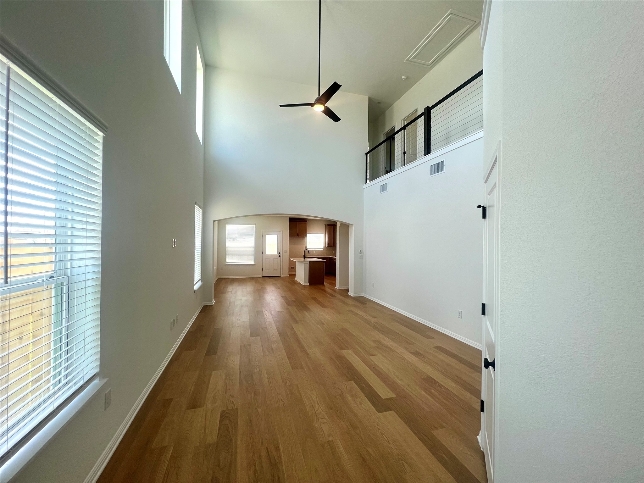 365 Young Street Buda, TX 78610 - Photo 3 of 27 a view of a hallway with wooden floor and staircase