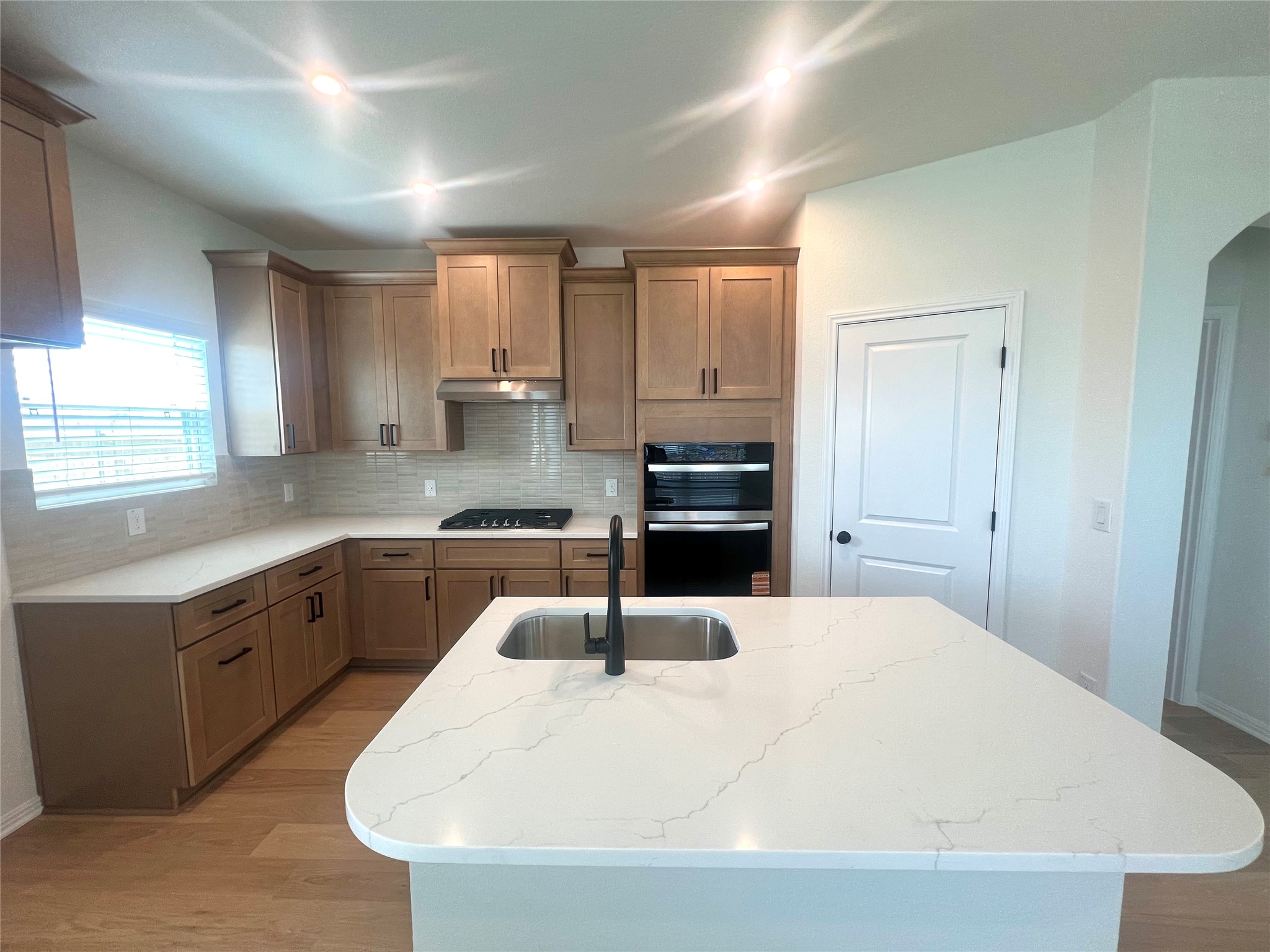 365 Young Street Buda, TX 78610 - Photo 5 of 27 a kitchen with stainless steel appliances a sink a stove a refrigerator cabinets and a window