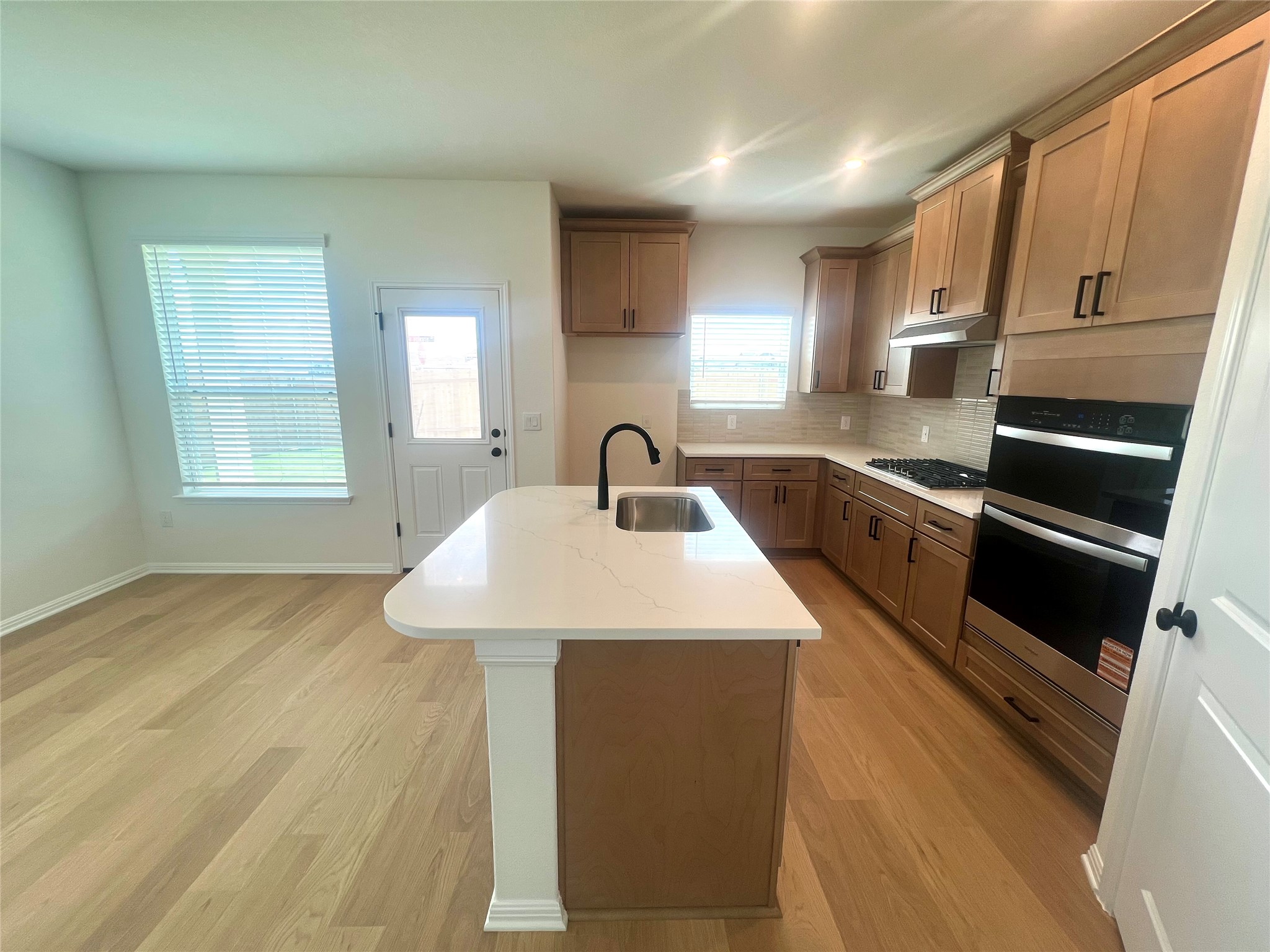 365 Young Street Buda, TX 78610 - Photo 6 of 27 a kitchen with stainless steel appliances a sink stove and cabinets