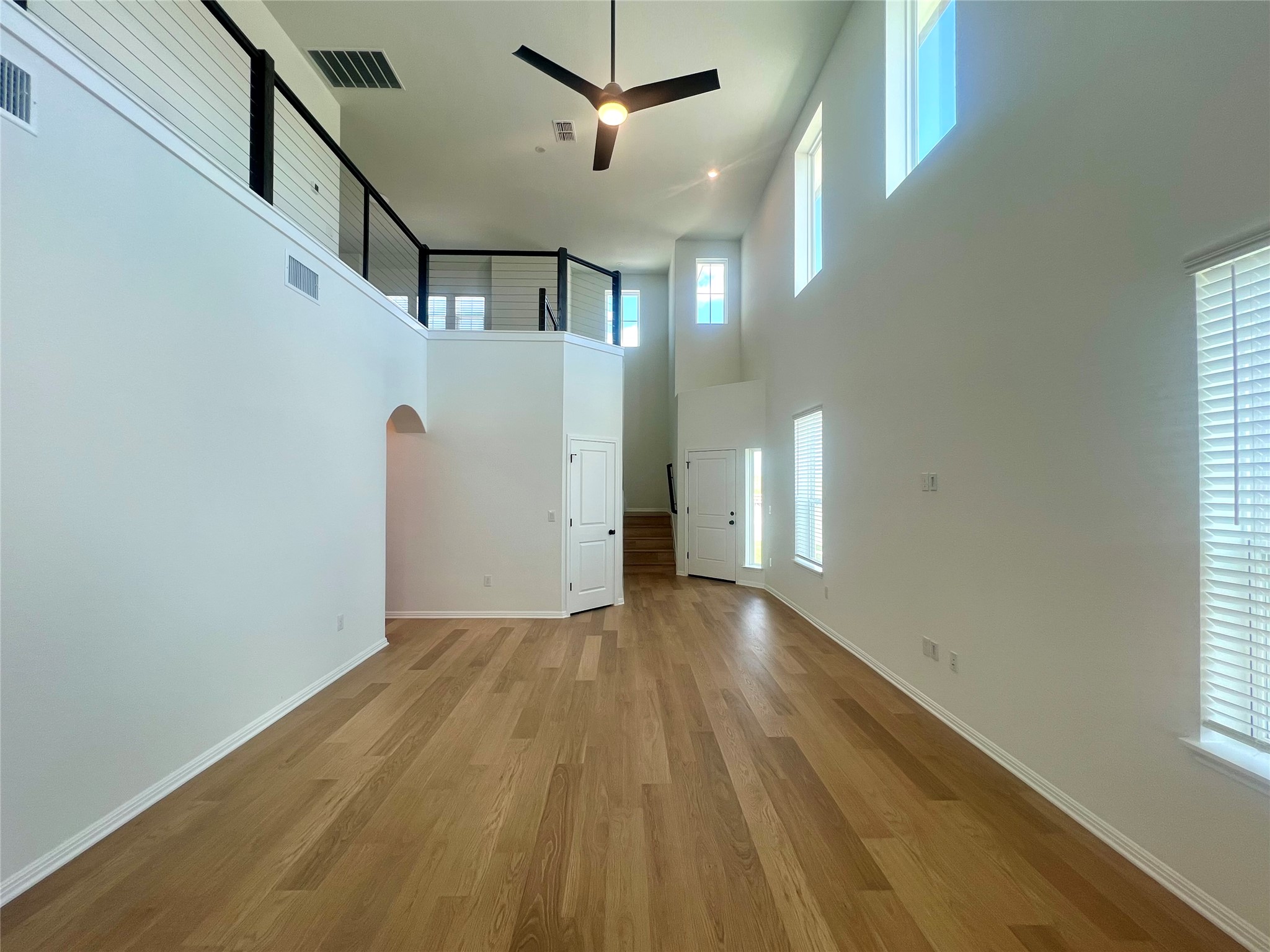 365 Young Street Buda, TX 78610 - Photo 7 of 27 a view of an empty room with wooden floor and a window
