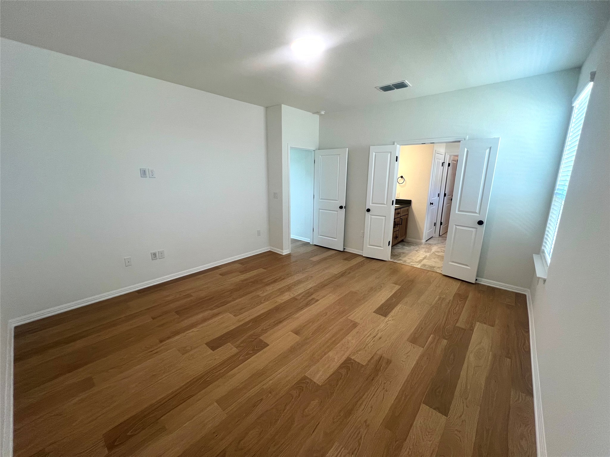 365 Young Street Buda, TX 78610 - Photo 8 of 27 a view of a room with wooden floor and natural light