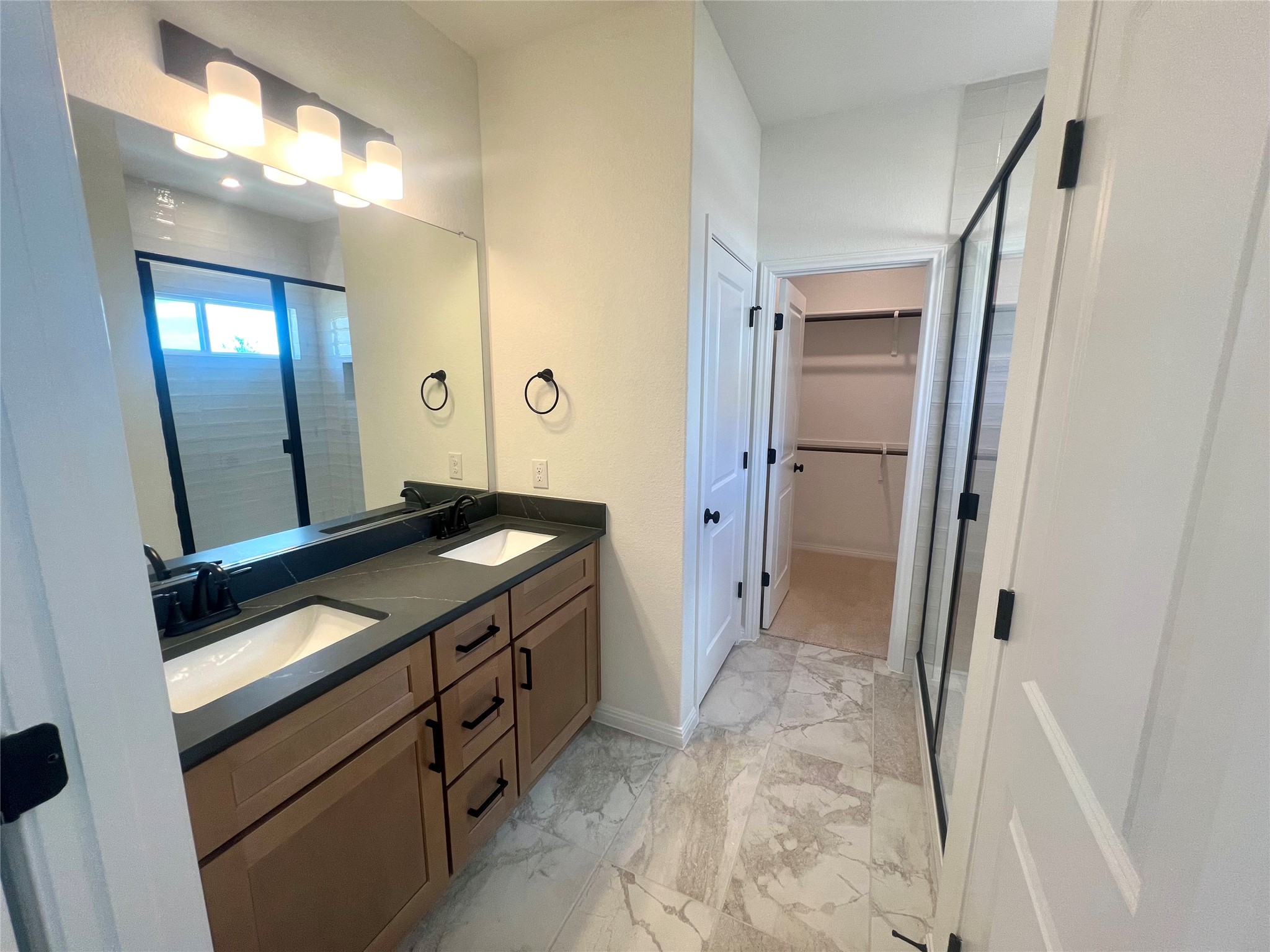 365 Young Street Buda, TX 78610 - Photo 9 of 27 a bathroom with a sink and a mirror