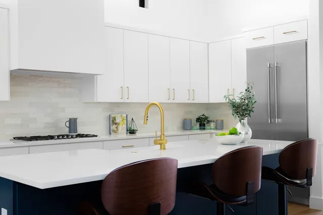 a kitchen with a table chairs stove and cabinets