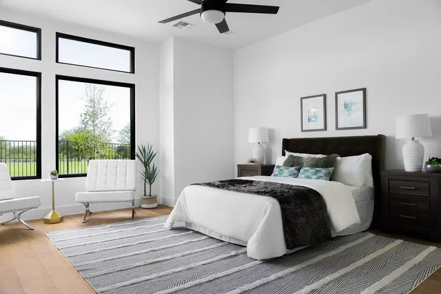 a bedroom with a bed and a large window