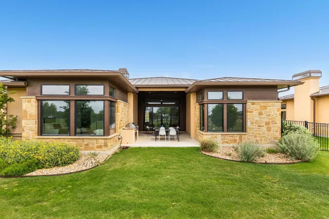 a front view of a house with a yard garage and outdoor seating