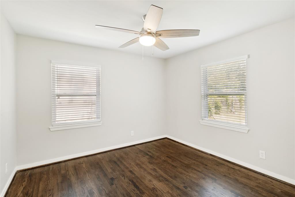 11524 Strand Street Dallas, TX 75218 - Photo 11 of 19 a view of an empty room with wooden floor and a window