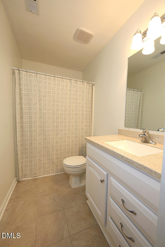 3555 Mill Run Raleigh, NC 27612 - Photo 13 of 25 a bathroom with a granite countertop bathtub sink vanity and toilet