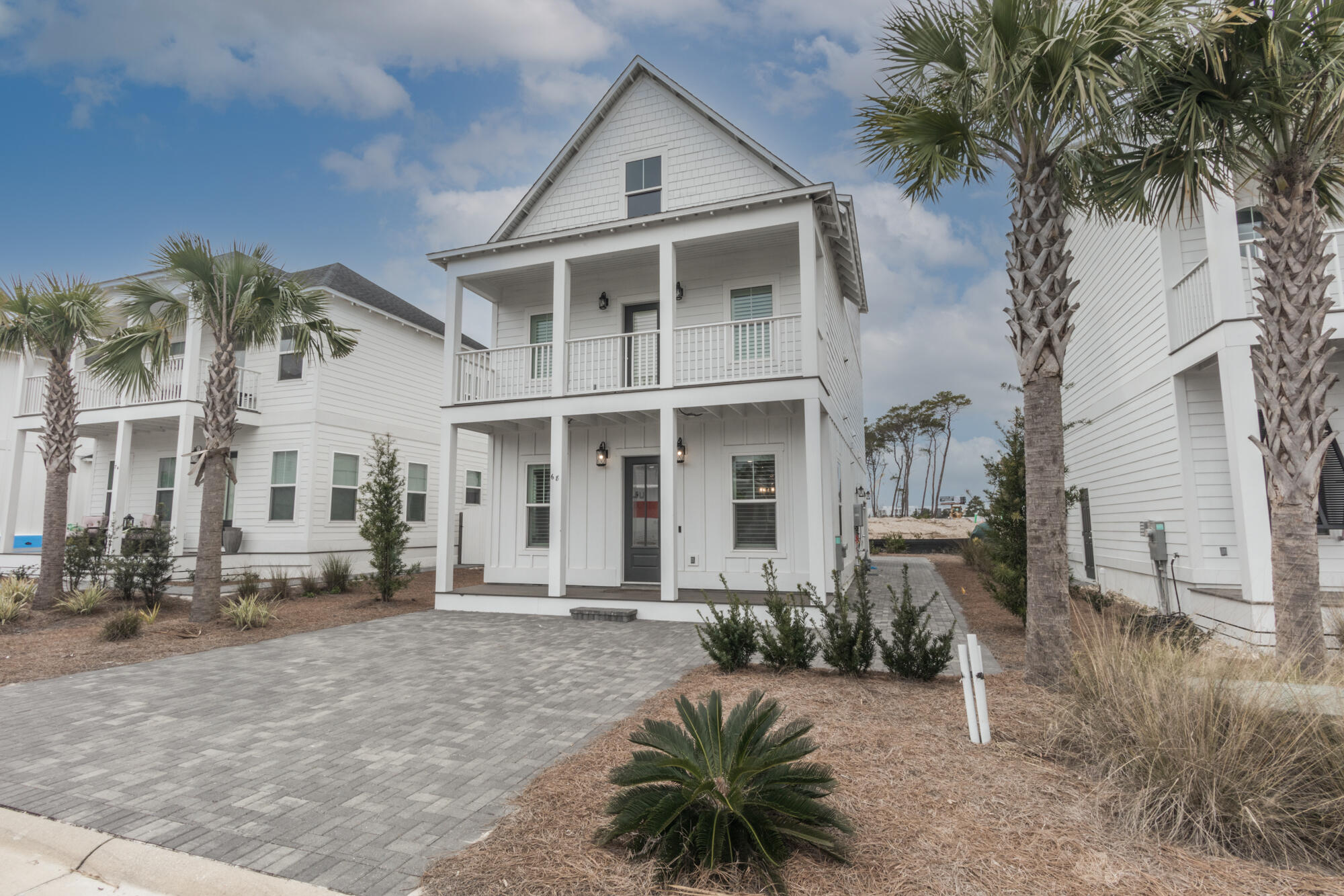68 Beach View Drive Inlet Beach, FL 32461 - Photo 5 of 78 a front view of a house with a yard garage and outdoor seating