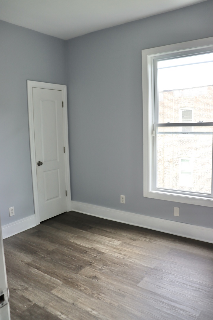 5718 South Sangamon Street, Unit 2 Chicago, IL 60621 - Photo 15 of 35 a view of an empty room with wooden floor and a window
