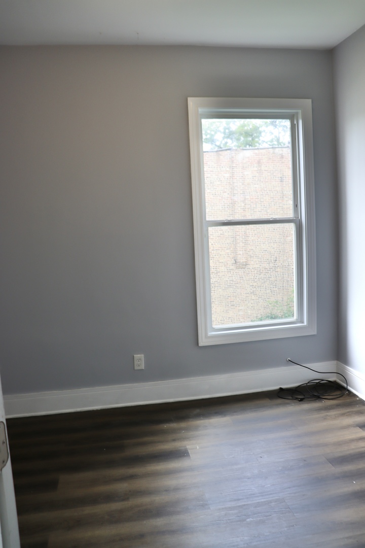 5718 South Sangamon Street, Unit 2 Chicago, IL 60621 - Photo 18 of 35 an empty room with wooden floor and windows