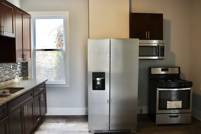a kitchen with stainless steel appliances a refrigerator stove and microwave