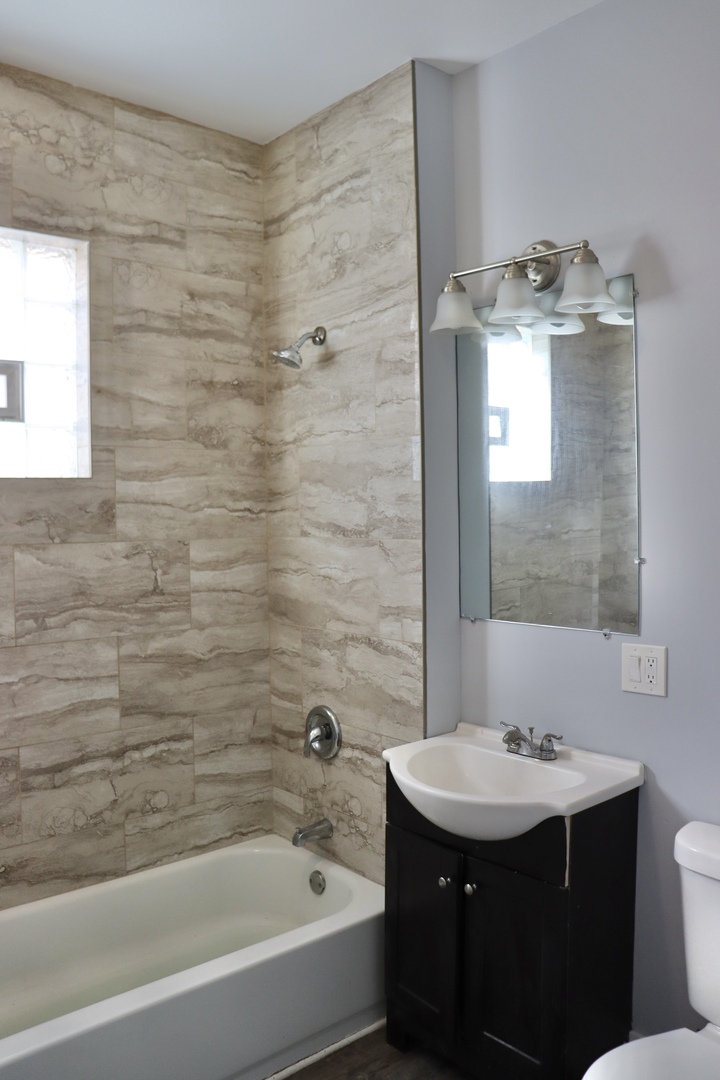 5718 South Sangamon Street, Unit 2 Chicago, IL 60621 - Photo 28 of 35 a bathroom with a sink and a mirror