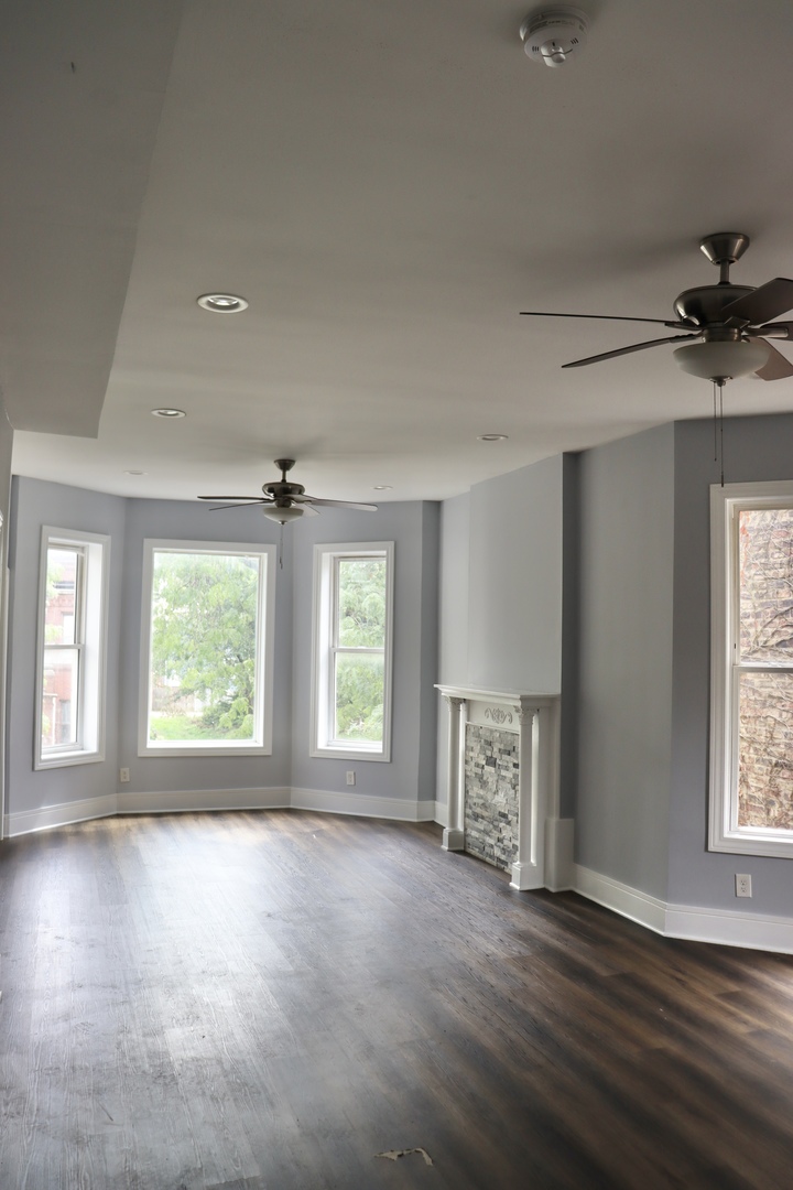 5718 South Sangamon Street, Unit 2 Chicago, IL 60621 - Photo 9 of 35 a view of an empty room with a window and wooden floor