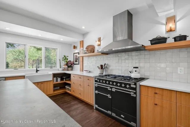 a kitchen with stainless steel appliances granite countertop a stove and a sink