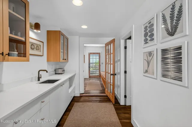 a bathroom with a sink mirror and toilet