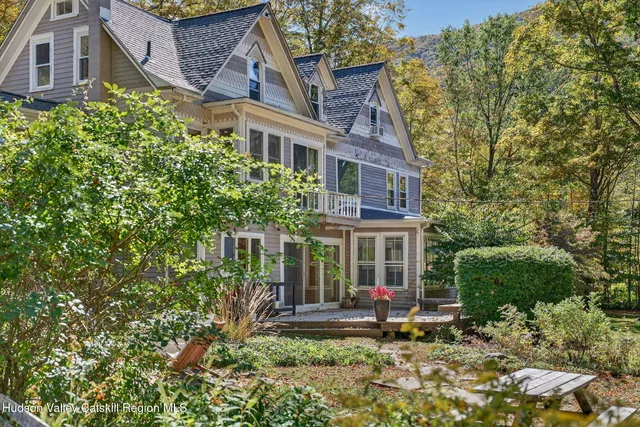 a view of a house with a small yard and a garden