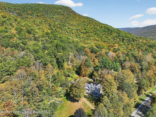 an aerial view of a house with a yard