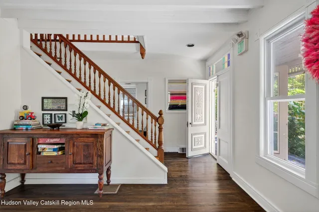 a view of entryway and hall with wooden floor