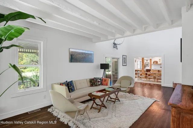 a living room with furniture wooden floor and a table