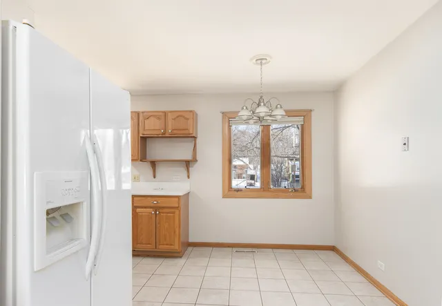 a view of a kitchen with an empty space and window