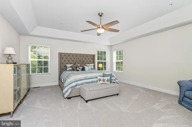 a spacious bedroom with a bed and a television