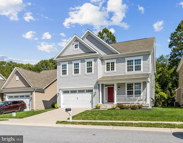 a front view of a house with a garden and plants