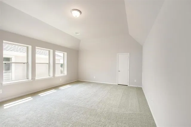 an empty room with a empty space and windows