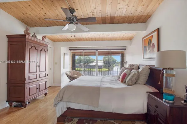 a bedroom with a bed mirror and window