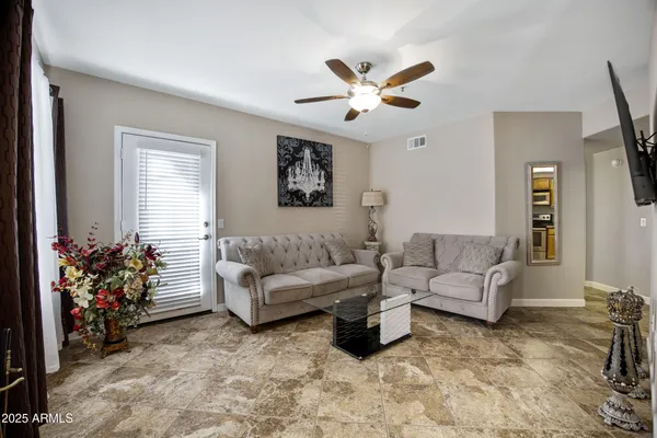 a living room with furniture and a large window