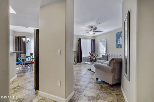 a living room with furniture and a chandelier