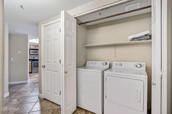 a view of storage and utility room with washer and dryer