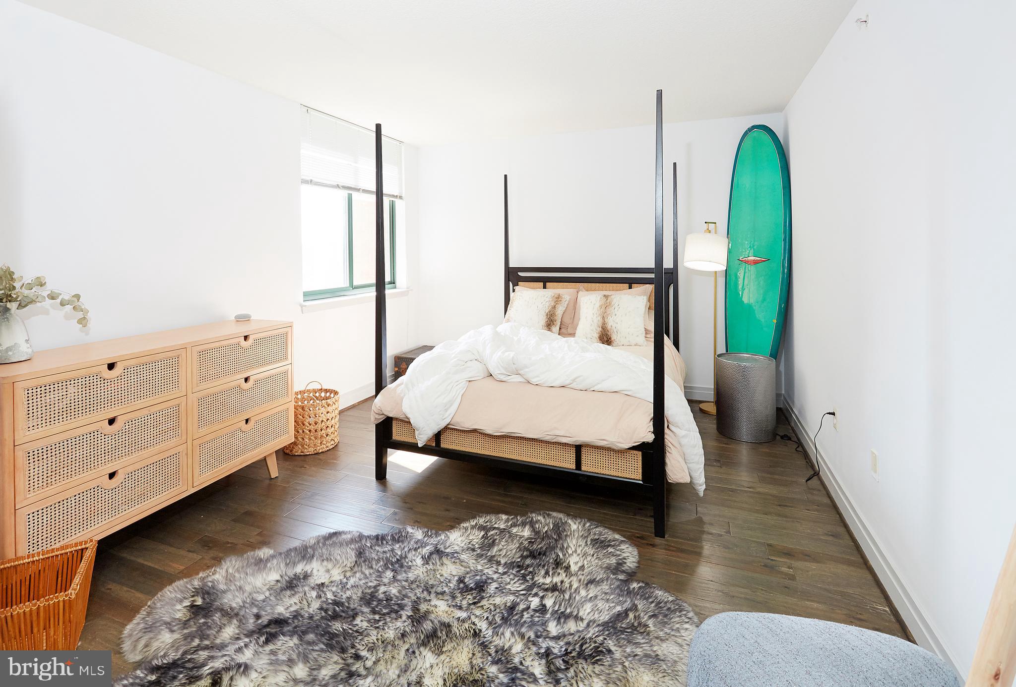 414 Water Street, Unit 2601 Baltimore, MD 21202 - Photo 18 of 51 a bedroom with a bed and a dresser