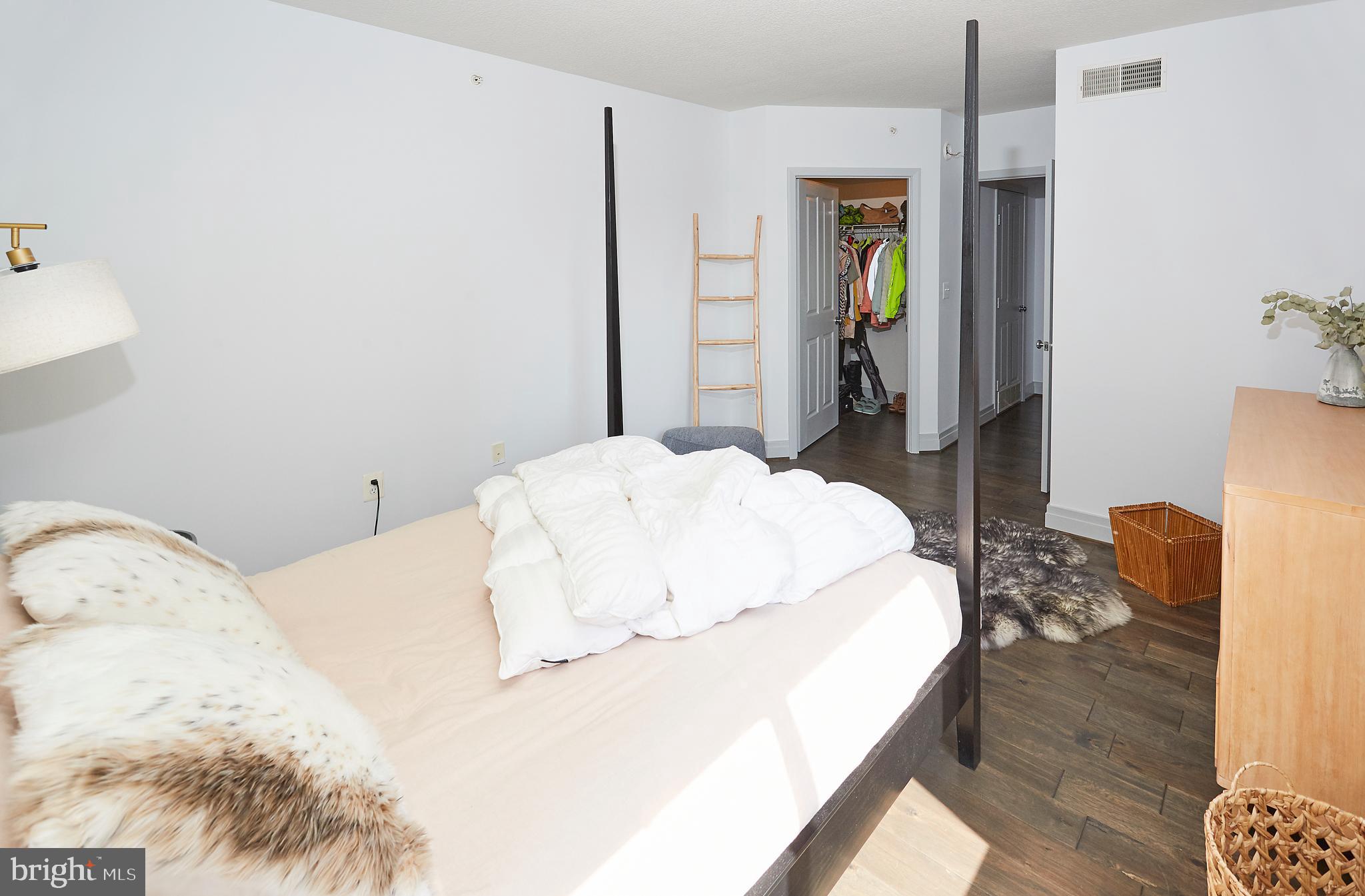 414 Water Street, Unit 2601 Baltimore, MD 21202 - Photo 21 of 51 a bedroom with a bed and a dresser