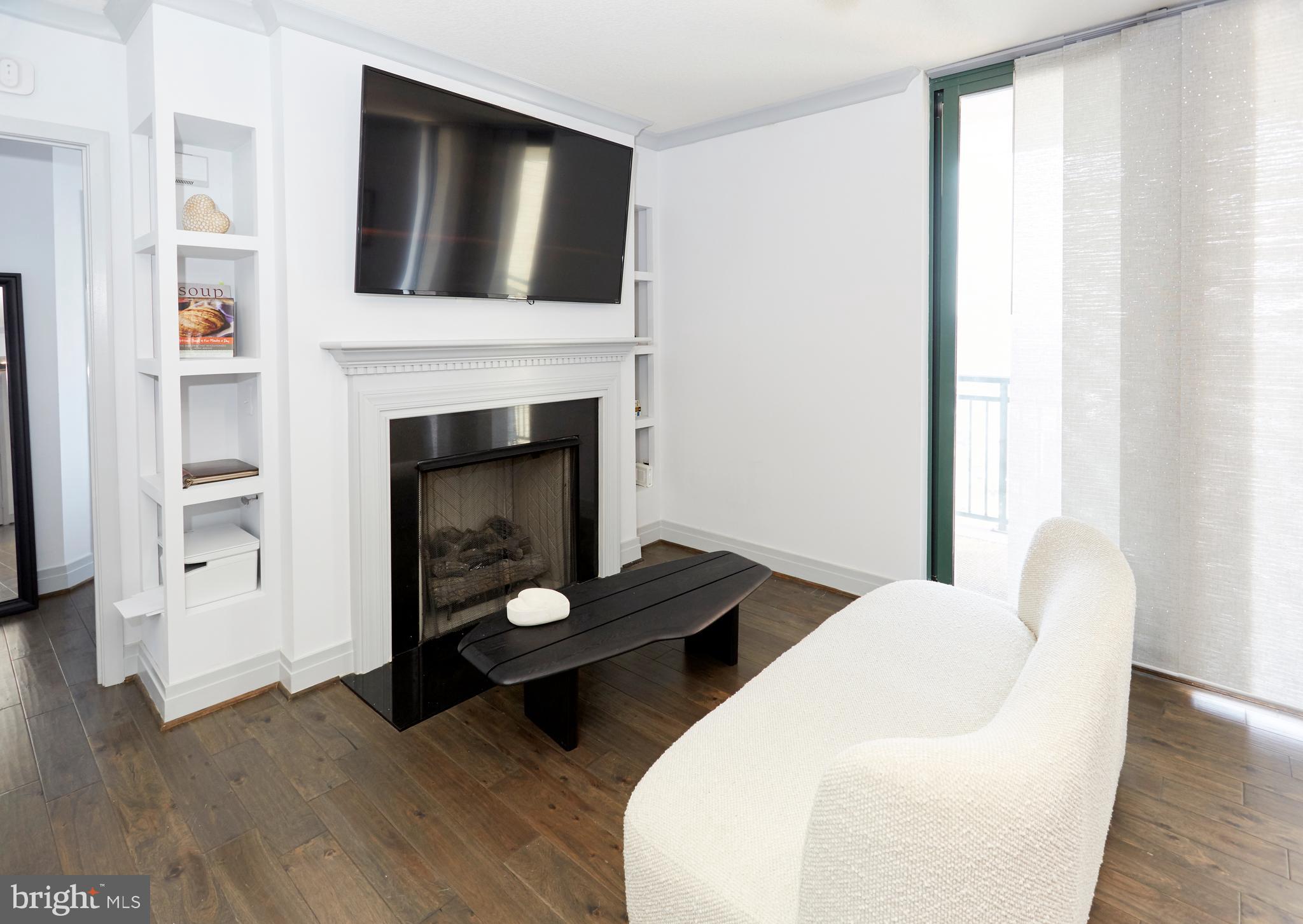 414 Water Street, Unit 2601 Baltimore, MD 21202 - Photo 3 of 51 a living room with furniture and a fireplace