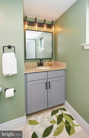 a bathroom with a sink a toilet and mirror