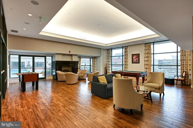 a open kitchen with stainless steel appliances granite countertop a stove and a wooden floors