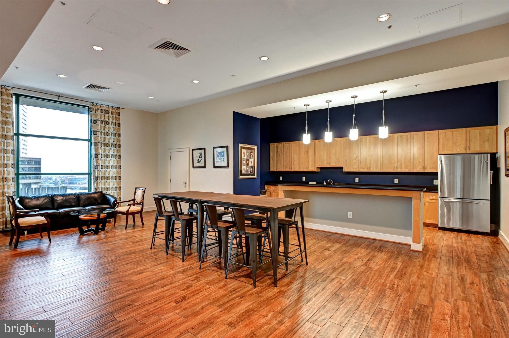 414 Water Street, Unit 2601 Baltimore, MD 21202 - Photo 44 of 51 a open kitchen with stainless steel appliances granite countertop a stove and a wooden floors