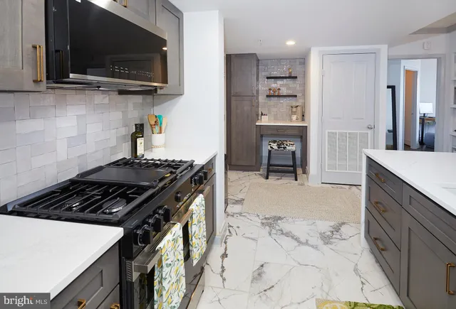 a kitchen with stainless steel appliances a stove a microwave and wooden cabinets