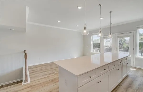 a view of a kitchen with counter top space and wooden floor