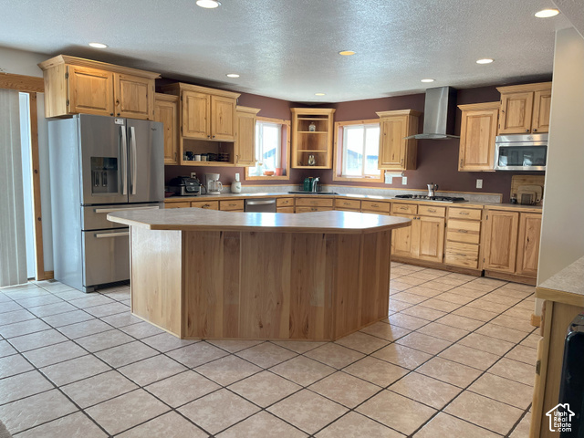 750 South Big Road Soda Springs, ID 83276 - Photo 21 of 40 Kitchen featuring a large central island, light wood cabinetry, stainless steel appliances, and tile flooring