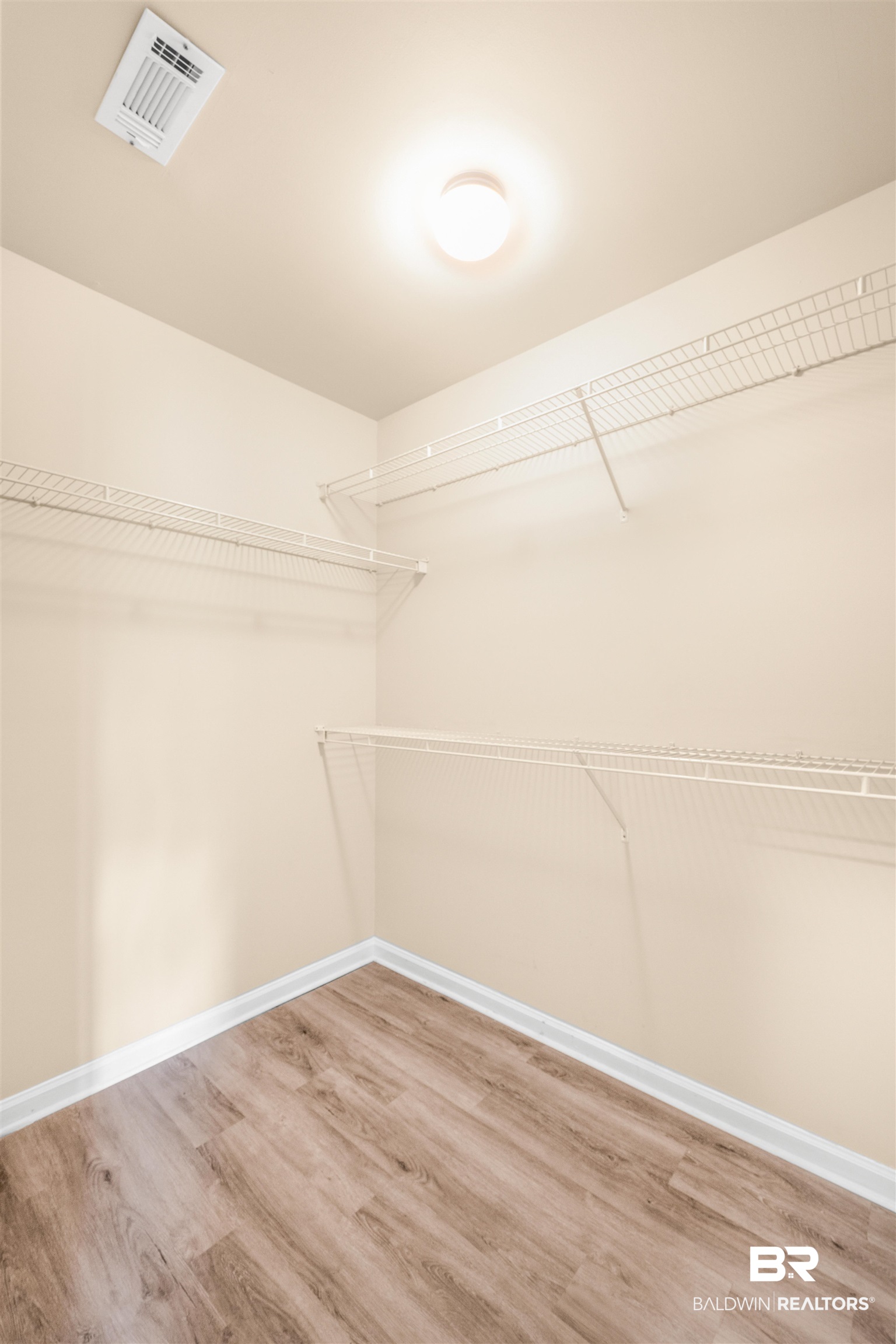 1517 Regency Road, Unit 85 Gulf Shores, AL 36542 - Photo 11 of 32 Spacious closet with wood-type flooring