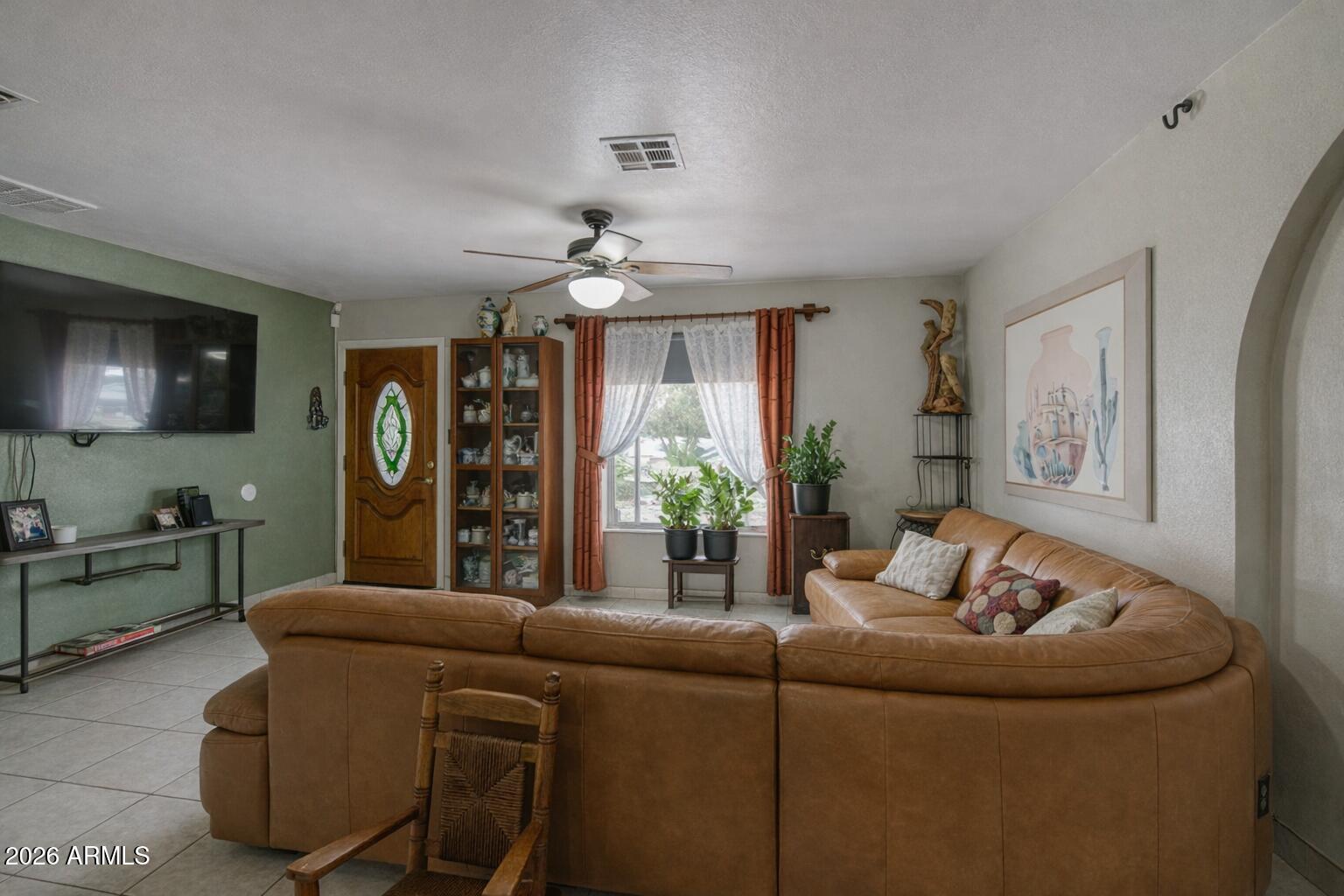 3107 West Montebello Avenue Phoenix, AZ 85017 - Photo 7 of 30 a living room with furniture and a flat screen tv
