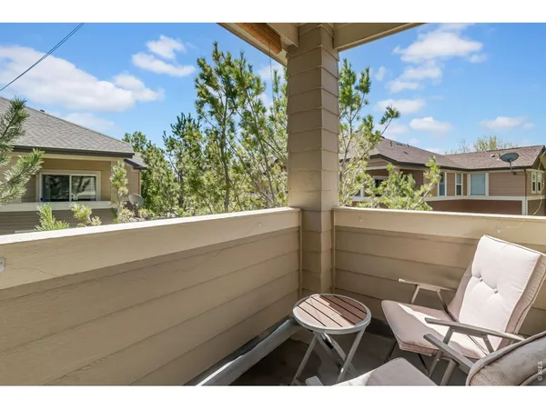 a view of a two chairs in a balcony