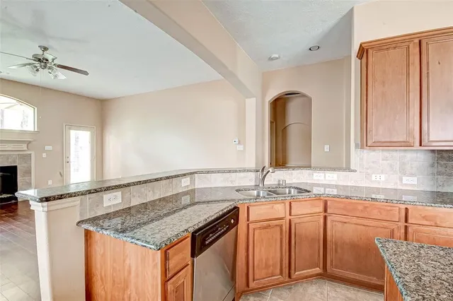 a bathroom with a granite countertop sink a mirror and vanity