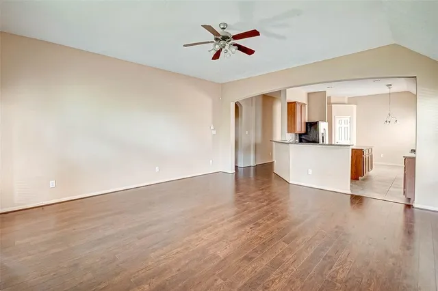 a view of a kitchen with wooden floor and a ceiling fan