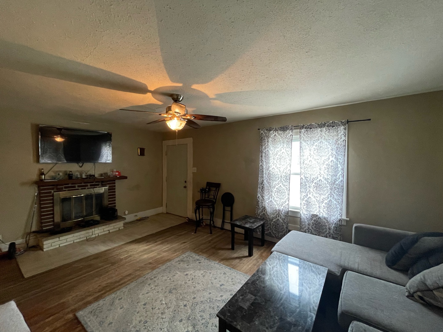 1434 East Clay Street Decatur, IL 62521 - Photo 4 of 16 a living room with furniture a fireplace and a flat screen tv
