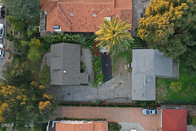 an aerial view of a house with a garden and a yard