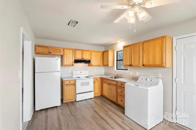 a kitchen with a stove a sink and a refrigerator