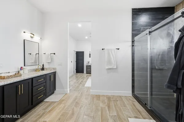 a bathroom with a double vanity sink and mirror