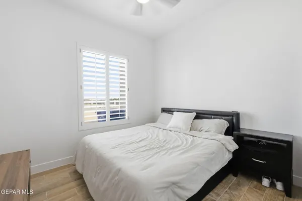 a bedroom with a bed and window